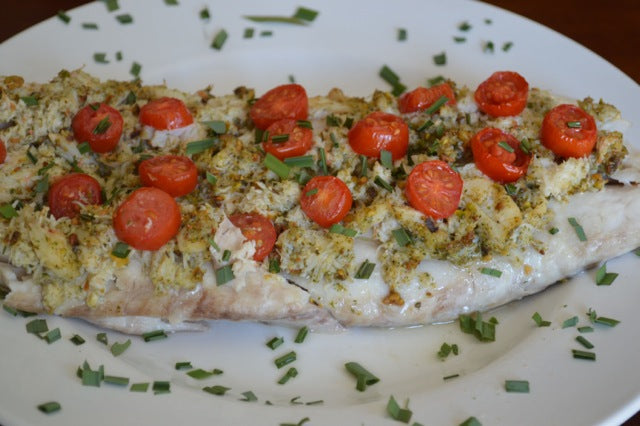 Cooked white fish with Nuts Over Fish Pistachio Topping
